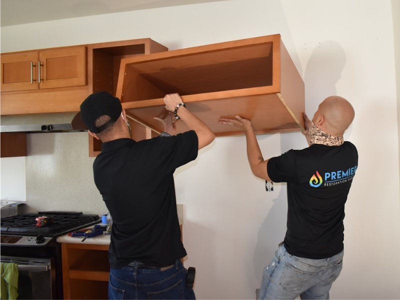 people installing cabinets